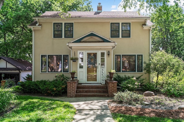 123 Franklin Ave, Owatonna, MN 55060 - view of front of house featuring stucco siding, a chimney, and entry steps