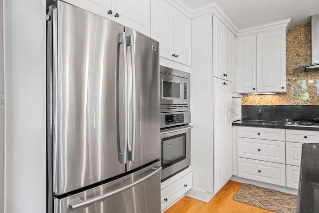 123 Franklin Ave, Owatonna, MN 55060 - kitchen with appliances with stainless steel finishes, dark countertops, white cabinets, and decorative backsplash