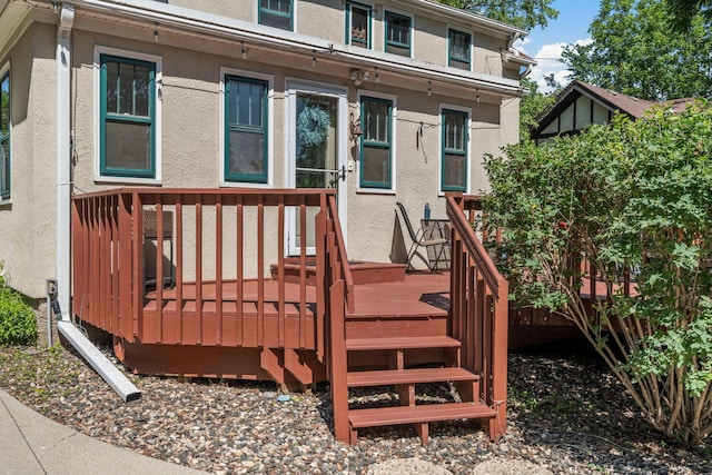 123 Franklin Ave, Owatonna, MN 55060 - doorway to property featuring stucco siding and a wooden deck