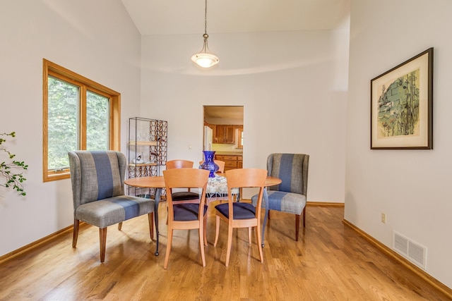 201 75th Ave N, Brooklyn Park, MN 55444 - dining area featuring light wood-style floors and a towering ceiling