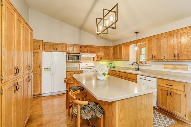 201 75th Ave N, Brooklyn Park, MN 55444 - kitchen with white appliances, under cabinet range hood, lofted ceiling, light countertops, and a kitchen breakfast bar