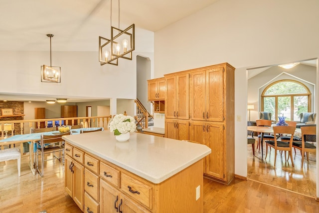201 75th Ave N, Brooklyn Park, MN 55444 - kitchen with a chandelier, a center island, light wood-style floors, light countertops, and pendant lighting