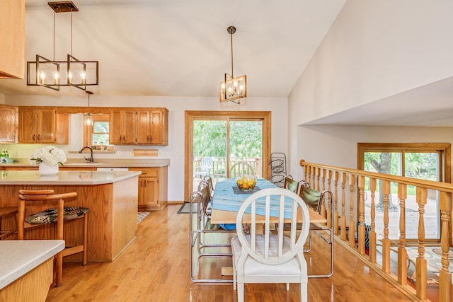 201 75th Ave N, Brooklyn Park, MN 55444 - dining room featuring a chandelier, healthy amount of natural light, light wood finished floors, and high vaulted ceiling