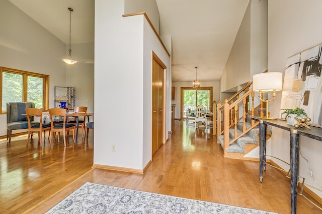 201 75th Ave N, Brooklyn Park, MN 55444 - foyer entrance with stairway, wood finished floors, a chandelier, and high vaulted ceiling