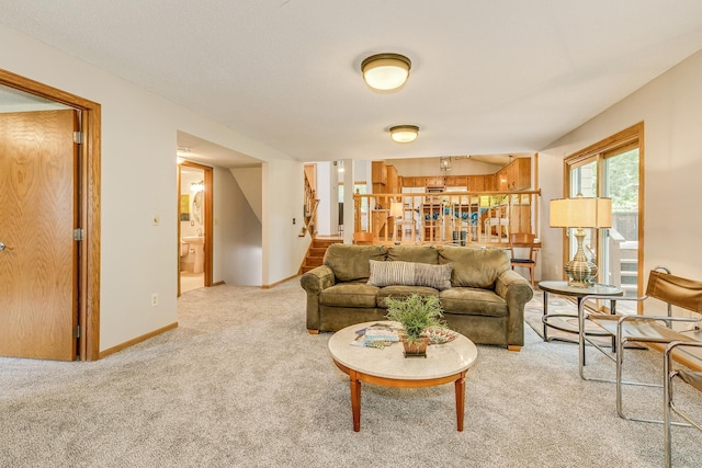 201 75th Ave N, Brooklyn Park, MN 55444 - carpeted living room with stairs and baseboards