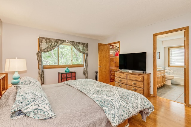 201 75th Ave N, Brooklyn Park, MN 55444 - bedroom with wood finished floors and connected bathroom