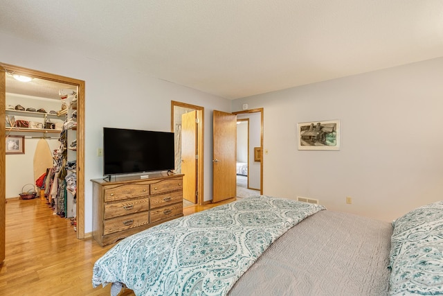 201 75th Ave N, Brooklyn Park, MN 55444 - bedroom with a spacious closet, light wood-style flooring, and a closet