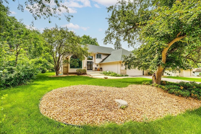 201 75th Ave N, Brooklyn Park, MN 55444 - view of front of home with a front lawn, a shingled roof, an attached garage, and concrete driveway