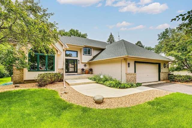 201 75th Ave N, Brooklyn Park, MN 55444 - view of front of home with driveway, a garage, brick siding, a front yard, and roof with shingles