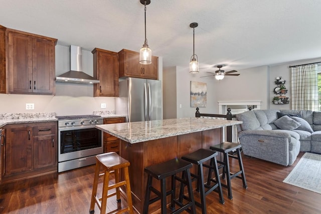 23481 Fontana St NE, Linwood Twp, MN 55079 - kitchen with stainless steel appliances, wall chimney exhaust hood, ceiling fan, open floor plan, and dark wood finished floors