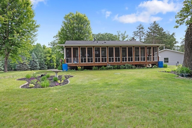 23481 Fontana St NE, Linwood Twp, MN 55079 - back of house featuring a sunroom, a yard, and a chimney