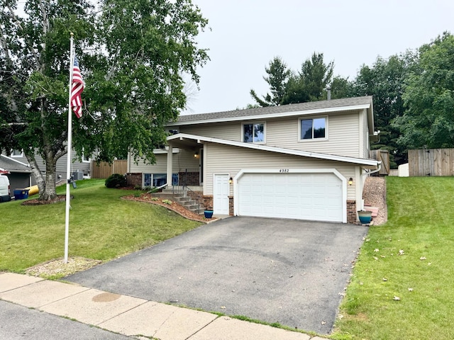 4982 148th Path W, Apple Valley, MN 55124 - raised ranch with a garage, brick siding, and asphalt driveway