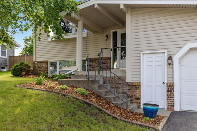 4982 148th Path W, Apple Valley, MN 55124 - view of exterior entry with a lawn, brick siding, and a garage
