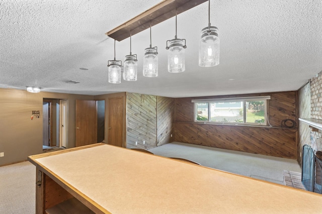 4982 148th Path W, Apple Valley, MN 55124 - bar featuring a textured ceiling, wood walls, carpet floors, a fireplace, and decorative light fixtures