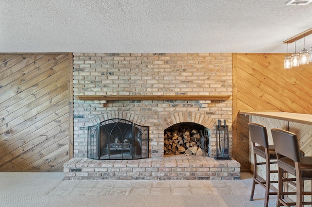 4982 148th Path W, Apple Valley, MN 55124 - living room with wood walls, a textured ceiling, a brick fireplace, and carpet