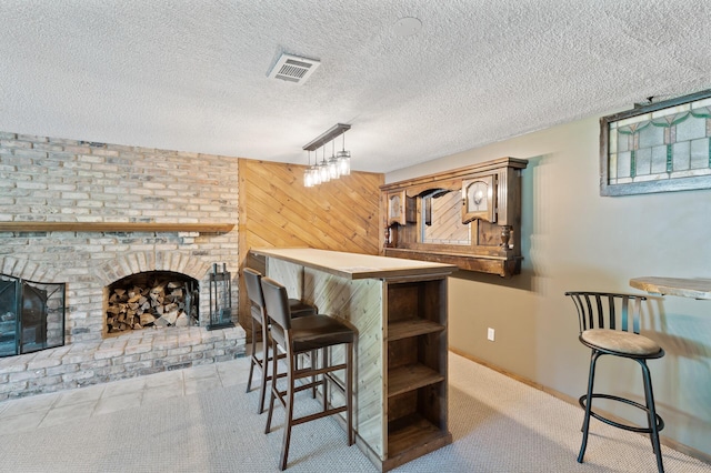 4982 148th Path W, Apple Valley, MN 55124 - bar featuring decorative light fixtures, wooden walls, a textured ceiling, and a brick fireplace
