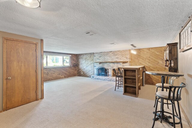 4982 148th Path W, Apple Valley, MN 55124 - carpeted living room with wood walls, a brick fireplace, and a textured ceiling