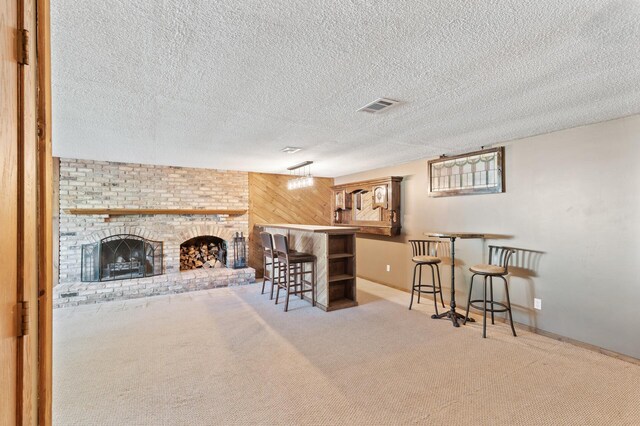 4982 148th Path W, Apple Valley, MN 55124 - indoor bar with carpet floors, a fireplace, a textured ceiling, and wood walls