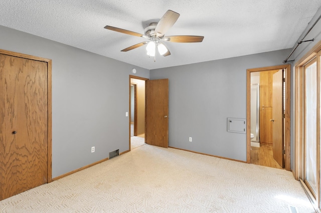 4982 148th Path W, Apple Valley, MN 55124 - unfurnished bedroom with carpet flooring, ensuite bathroom, ceiling fan, and a textured ceiling