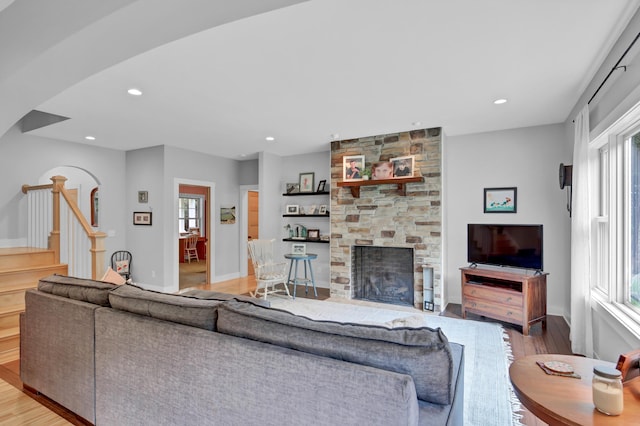 35853 Whispering Pine Way, Florence Twp, MN 55041 - living room with wood finished floors, stairway, a fireplace, recessed lighting, and arched walkways