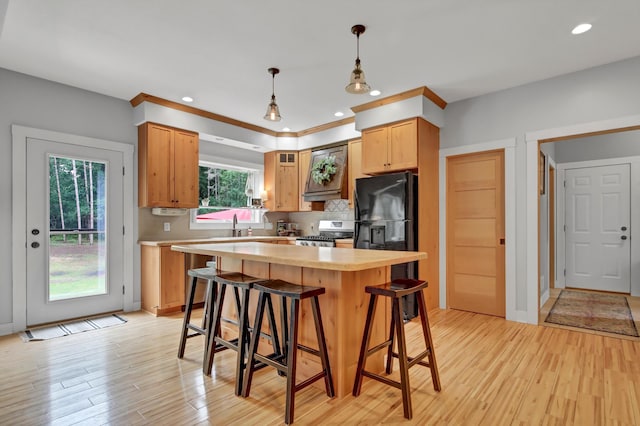 35853 Whispering Pine Way, Florence Twp, MN 55041 - kitchen featuring range, light countertops, a breakfast bar, light wood finished floors, and recessed lighting