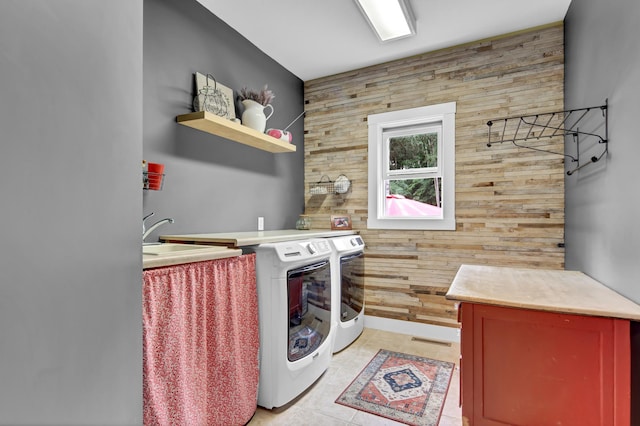 35853 Whispering Pine Way, Florence Twp, MN 55041 - laundry room featuring wooden walls, washer and clothes dryer, and an accent wall