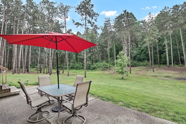 35853 Whispering Pine Way, Florence Twp, MN 55041 - view of patio featuring outdoor dining space and a forest view