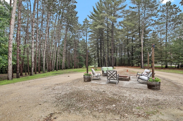 35853 Whispering Pine Way, Florence Twp, MN 55041 - view of yard with a fire pit, a patio area, and a wooded view