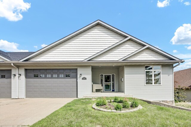 308 Iowa St, Lake City, MN 55041 - view of front of property featuring a garage, concrete driveway, and a front yard
