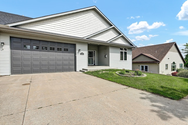 308 Iowa St, Lake City, MN 55041 - view of front of house with an attached garage, concrete driveway, and a front yard