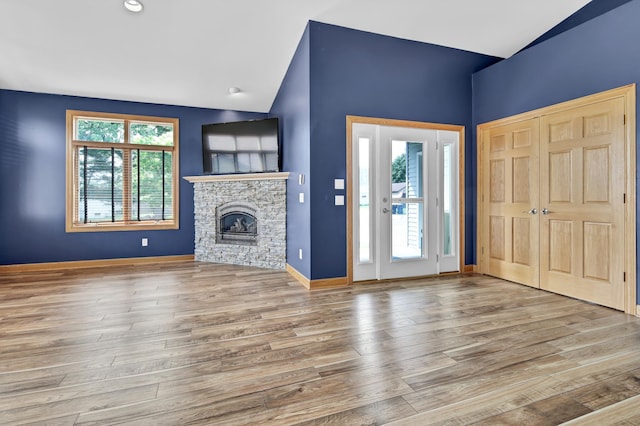 308 Iowa St, Lake City, MN 55041 - unfurnished living room featuring vaulted ceiling, wood finished floors, and a fireplace
