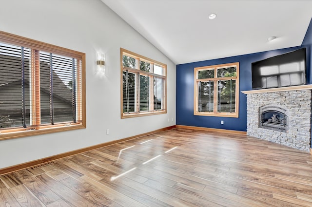 308 Iowa St, Lake City, MN 55041 - unfurnished living room featuring vaulted ceiling, wood finished floors, a fireplace, and recessed lighting