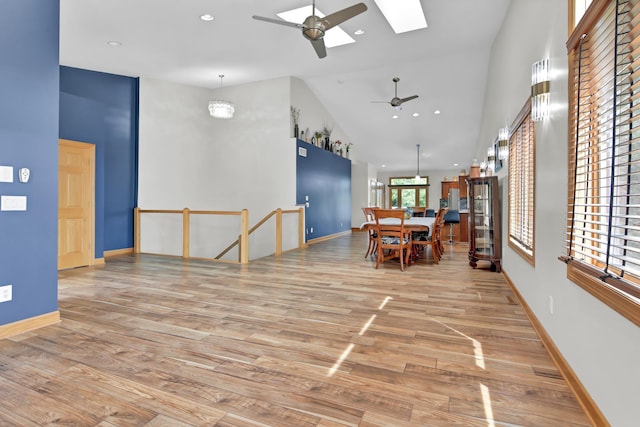 308 Iowa St, Lake City, MN 55041 - dining area with ceiling fan, a skylight, wood finished floors, high vaulted ceiling, and recessed lighting