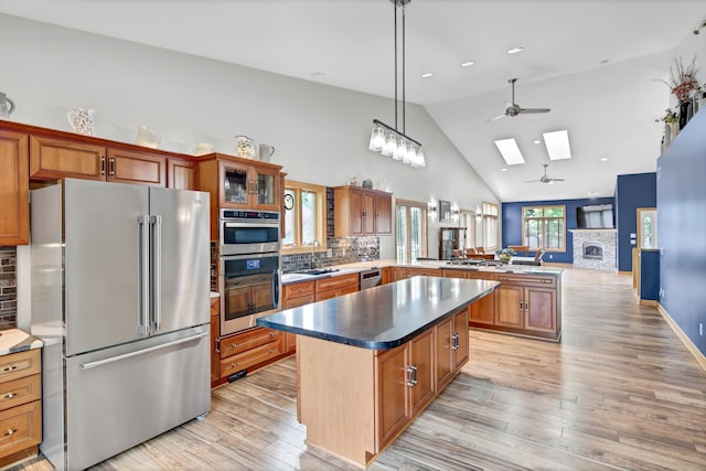 308 Iowa St, Lake City, MN 55041 - kitchen with stainless steel appliances, ceiling fan, a peninsula, a skylight, and decorative backsplash