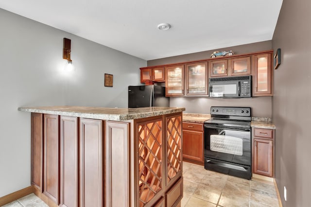308 Iowa St, Lake City, MN 55041 - kitchen featuring black appliances, glass insert cabinets, brown cabinets, and a peninsula