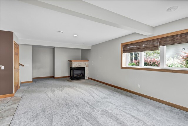 308 Iowa St, Lake City, MN 55041 - unfurnished living room featuring a tiled fireplace, light colored carpet, and recessed lighting