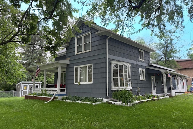 580 Davis St, Hammond, WI 54015 - view of home's exterior with a yard, a porch, and a storage shed