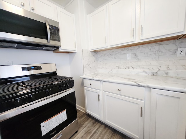 1222 8th Ave SE, Rochester, MN 55904 - kitchen featuring appliances with stainless steel finishes, white cabinets, backsplash, and wood finished floors