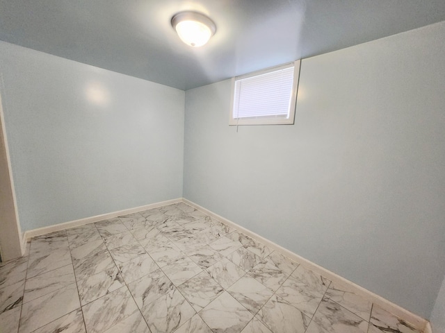 1222 8th Ave SE, Rochester, MN 55904 - below grade area featuring marble look tile flooring and baseboards