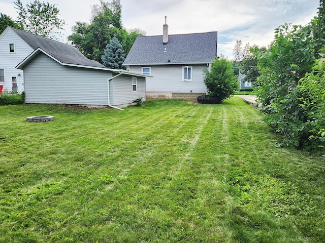 1222 8th Ave SE, Rochester, MN 55904 - view of grassy yard featuring an outdoor fire pit
