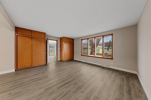 710 Jefferson St, New Ulm, MN 56073 - unfurnished bedroom with light wood-type flooring and baseboards