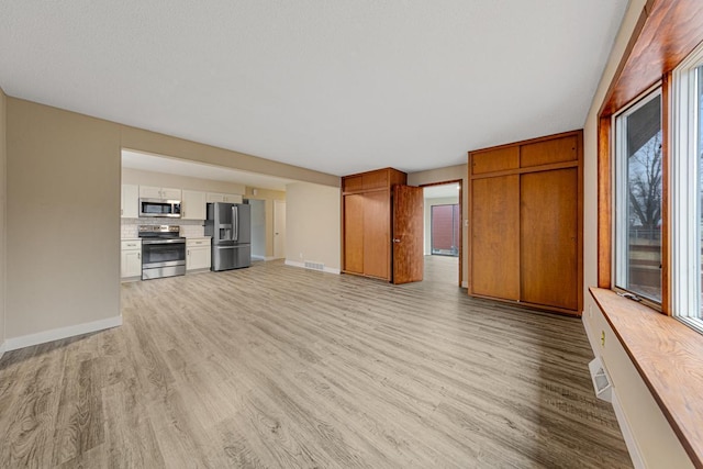 710 Jefferson St, New Ulm, MN 56073 - unfurnished living room featuring light wood-style floors