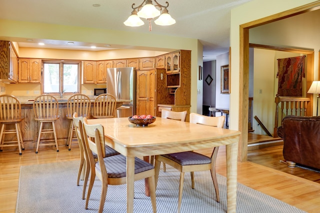13445 190th Ave NW, Elk River, MN 55330 - dining area with light wood-style flooring and a chandelier