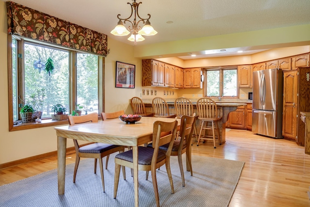 13445 190th Ave NW, Elk River, MN 55330 - dining space with a chandelier and light wood-style floors