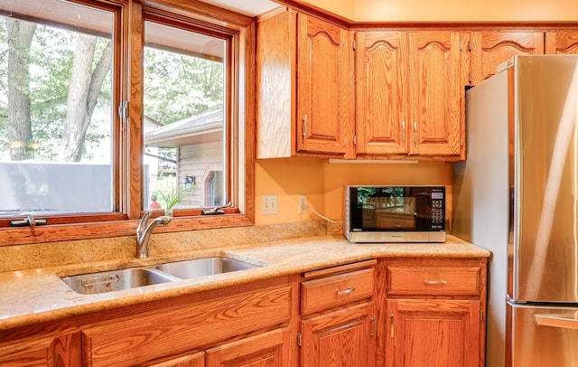 13445 190th Ave NW, Elk River, MN 55330 - kitchen featuring freestanding refrigerator, black microwave, and brown cabinets
