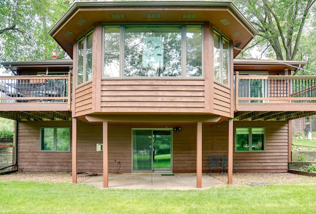 13445 190th Ave NW, Elk River, MN 55330 - back of property featuring a patio area, a sunroom, and a yard
