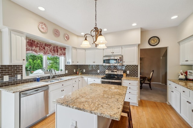 8017 Lismore Cir, Eden Prairie, MN 55347 - kitchen with appliances with stainless steel finishes, light wood-style floors, white cabinetry, and recessed lighting