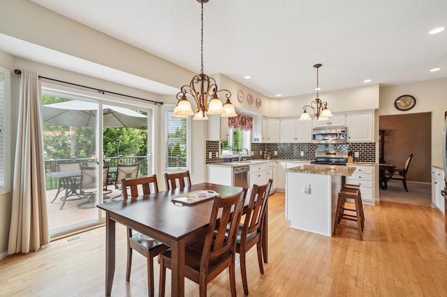 8017 Lismore Cir, Eden Prairie, MN 55347 - dining room featuring a chandelier, healthy amount of natural light, light wood-style flooring, and recessed lighting