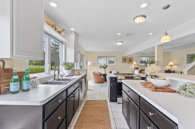 12329 Timber Ln, Maple Grove, MN 55369 - kitchen with appliances with stainless steel finishes, light countertops, open floor plan, pendant lighting, and dark cabinets