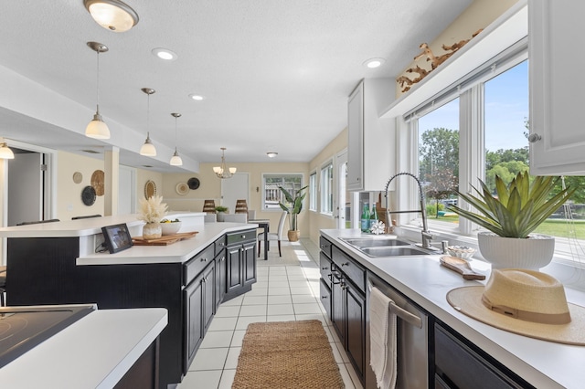 12329 Timber Ln, Maple Grove, MN 55369 - kitchen with stainless steel dishwasher, light countertops, decorative light fixtures, recessed lighting, and light tile patterned flooring